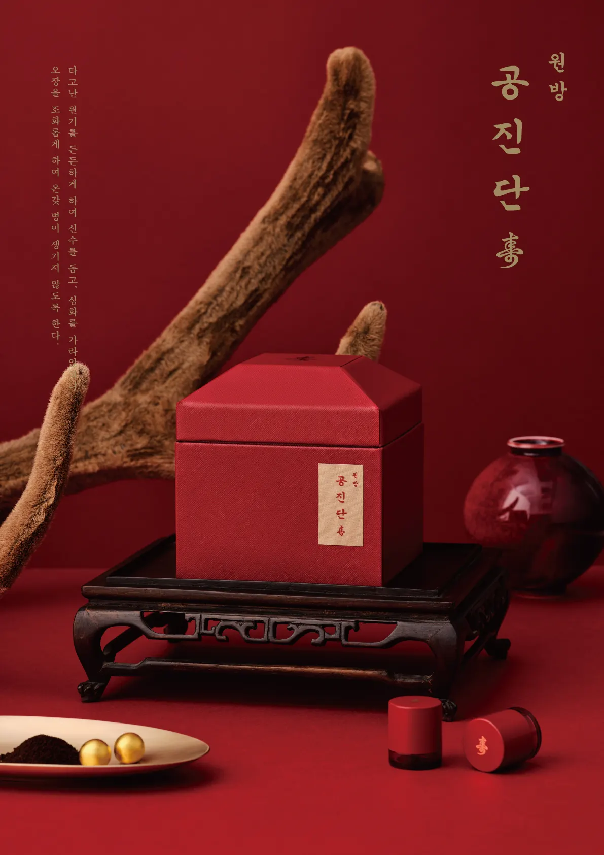 붉은 배경에 녹용 뿔과 함께 놓인 원방공진단 상자와 환
